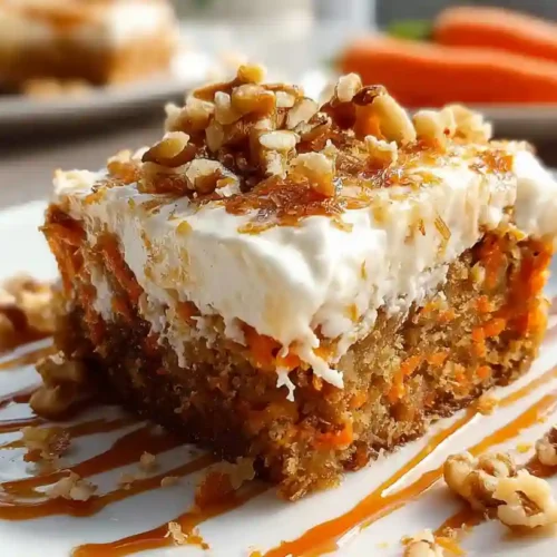 Slice of carrot poke cake with cream cheese frosting and walnuts on white plate with fork
