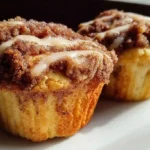 Coffee cake muffins with buttery crumble topping and cinnamon swirl on wooden board