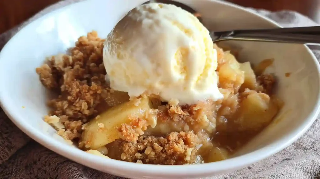 Sugar Free Apple Crisp served in a bowl with fresh apples and oats