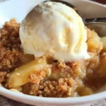 Sugar Free Apple Crisp served in a bowl with fresh apples and oats
