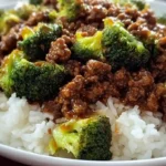 Honey garlic beef dish with ground beef and fresh broccoli served in a bowl.