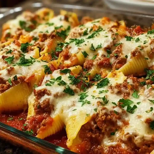 Cheesy stuffed pasta shells filled with ground beef, topped with marinara sauce.
