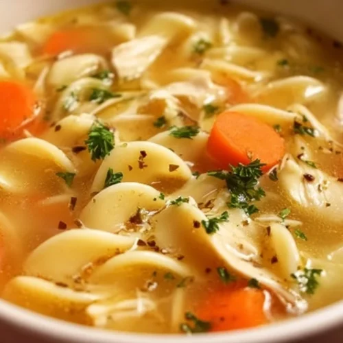 Bowl of homemade crockpot chicken noodle soup with vegetables